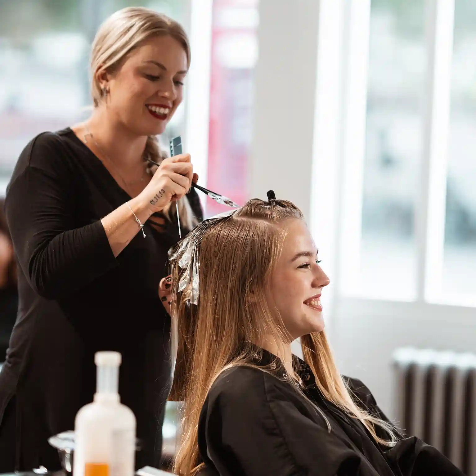 Woman having hair foils