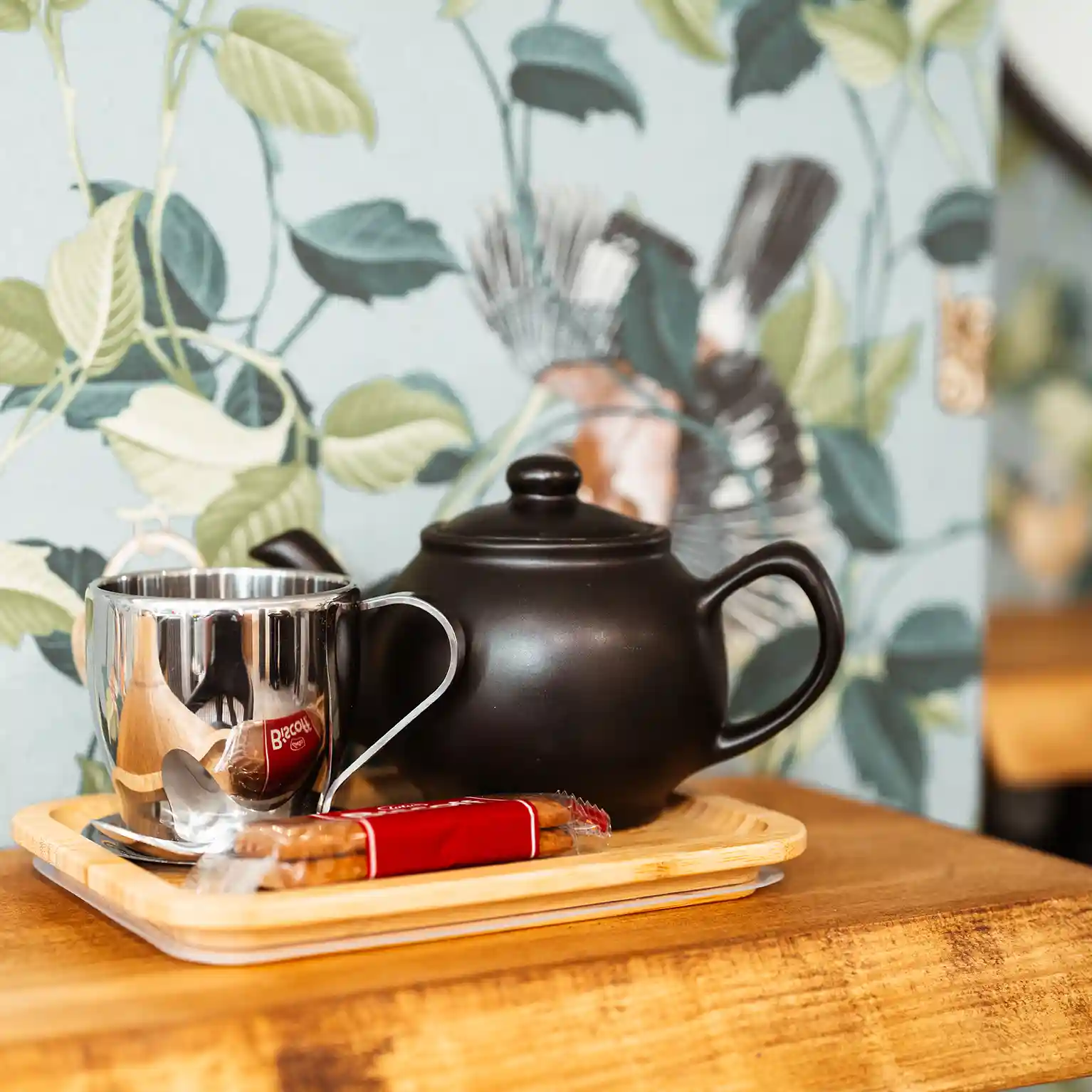 Close up of a tray with a pot of tea and Lotus biscuits